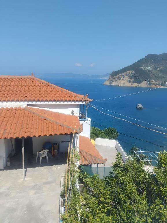a house with a view of the ocean at Waves of Millos in Skopelos Town