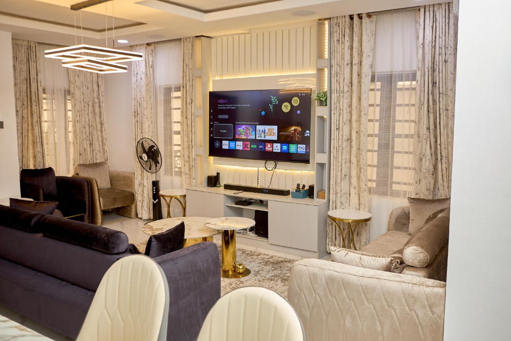 a living room with a couch and a tv at Lekki Abijo Apartment in Lekki