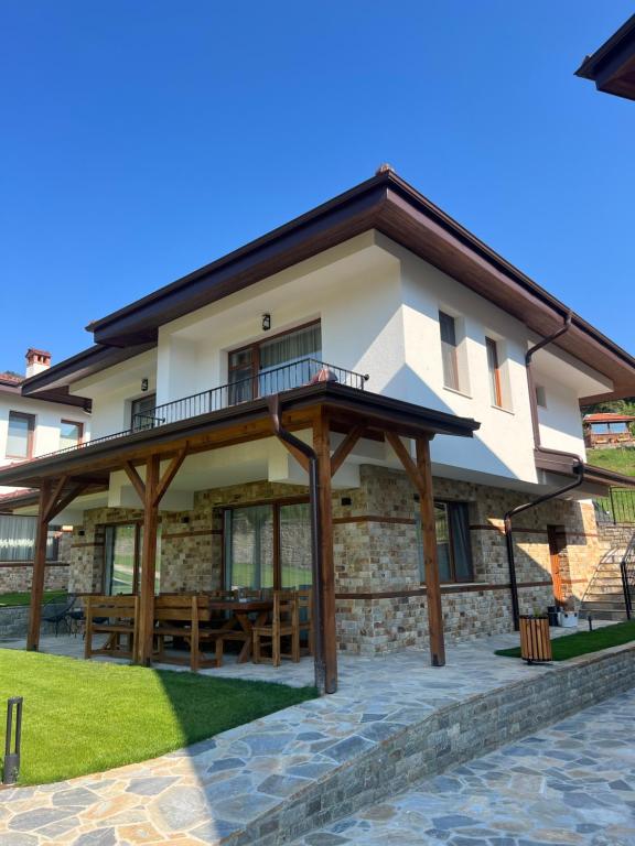 a house with a pavilion in front of it at SPA Apartament Daffi in Smolyan