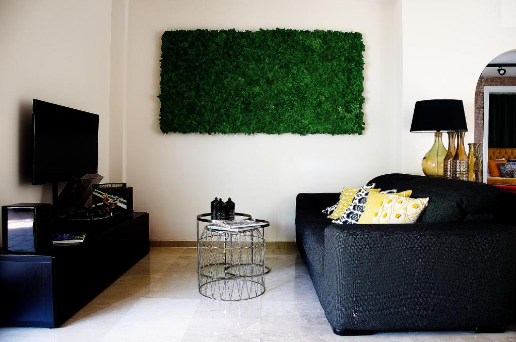 Televízia a/alebo spoločenská miestnosť v ubytovaní Botanic Home