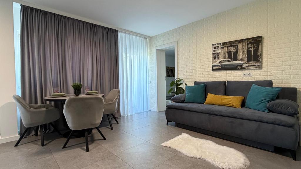 a living room with a couch and a table at Novus Luxury Apartment Free Parking in Craiova