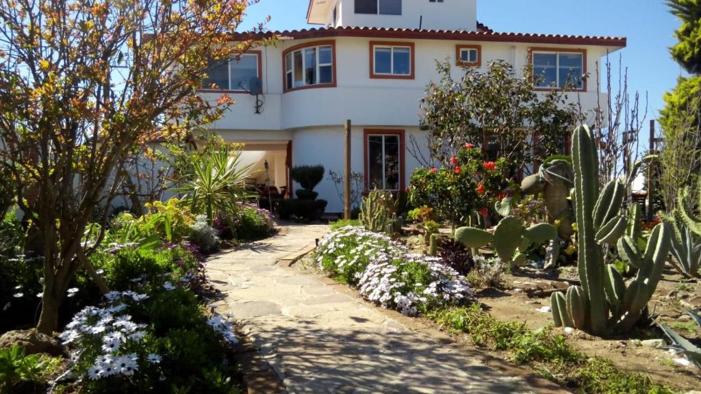a house with a garden in front of it at Casa Lagunita in Ensenada