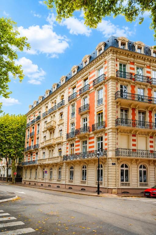 a large building on the side of a street at RoomChic - Les Ambassadeurs in Vichy