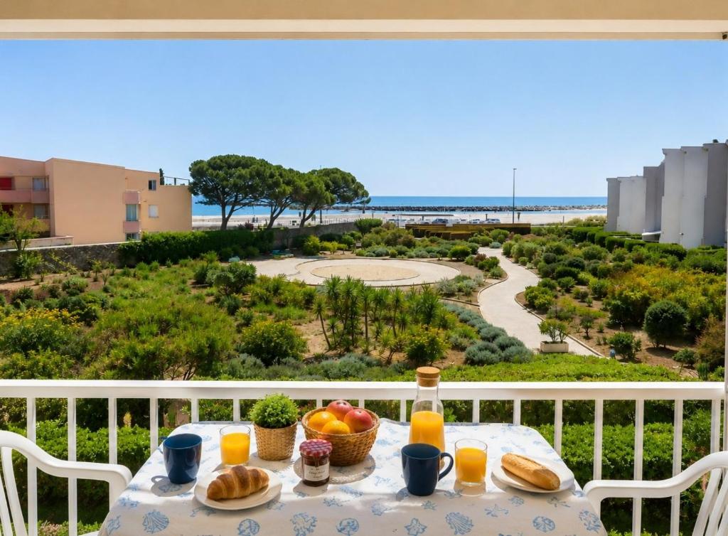 a table with bread and fruit on a balcony with a view at El Rivet - appartement vue mer avec parking in Sète
