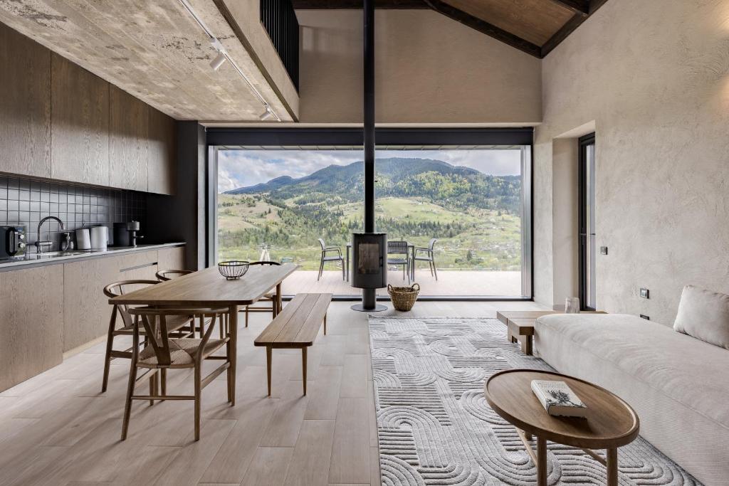 a living room with a couch and a table and a fireplace at Krasnyk Resort in Verkhovyna