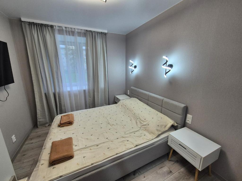 a small bedroom with a bed and a window at 2-room apartment with separate rooms in Narva