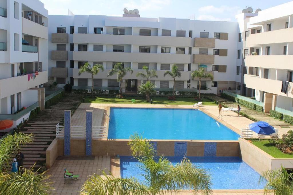 a swimming pool in front of a building at Paradise évasion Bord de Mer avec Piscine in Pont Blondin