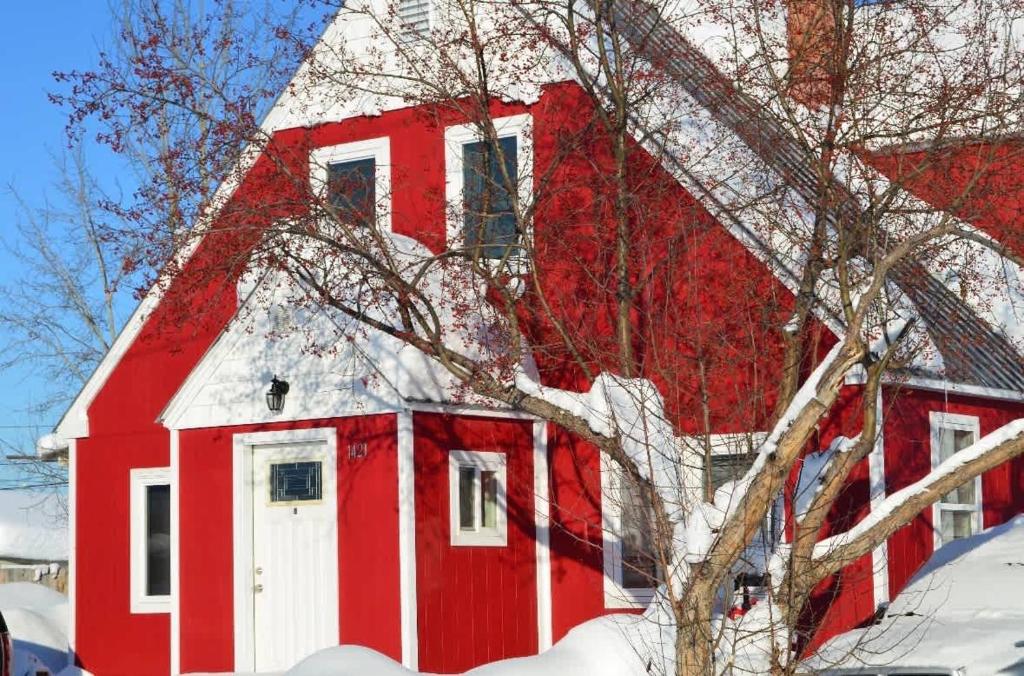 a red barn with snow on the side of it at The Downtown Loft in Fairbanks