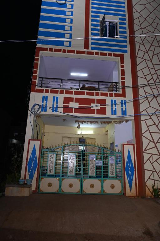 an outside view of a building at night at Gitanjali Lodge in Rāmagiri Udayagiri