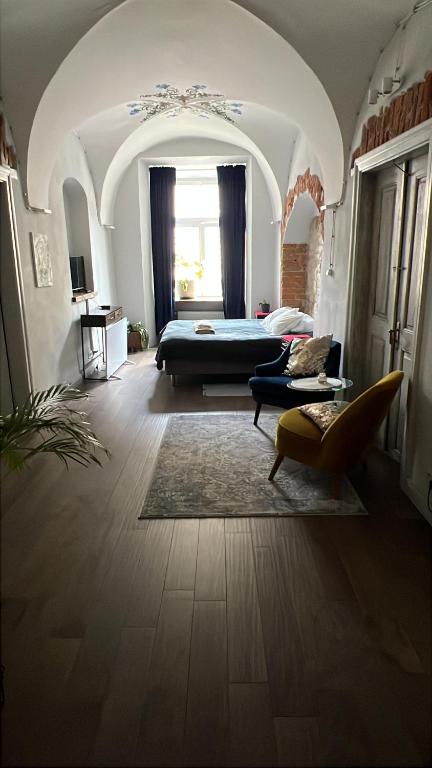 a bedroom with a bed and a couch in a room at Rynek 5 Winiarnia in Lublin