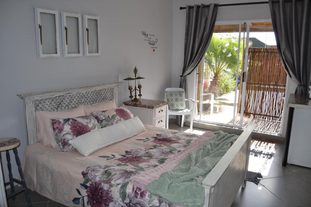 a bedroom with a bed and a balcony at Cozy Rustic Cottage in Windsor Park