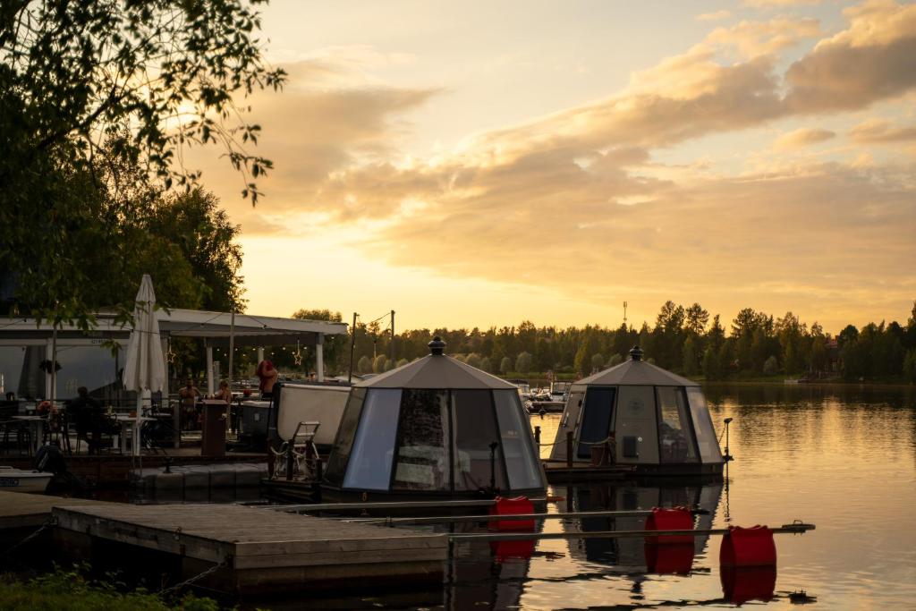 two boats are docked at a dock on a lake at Koivuranta Igloos in Oulu