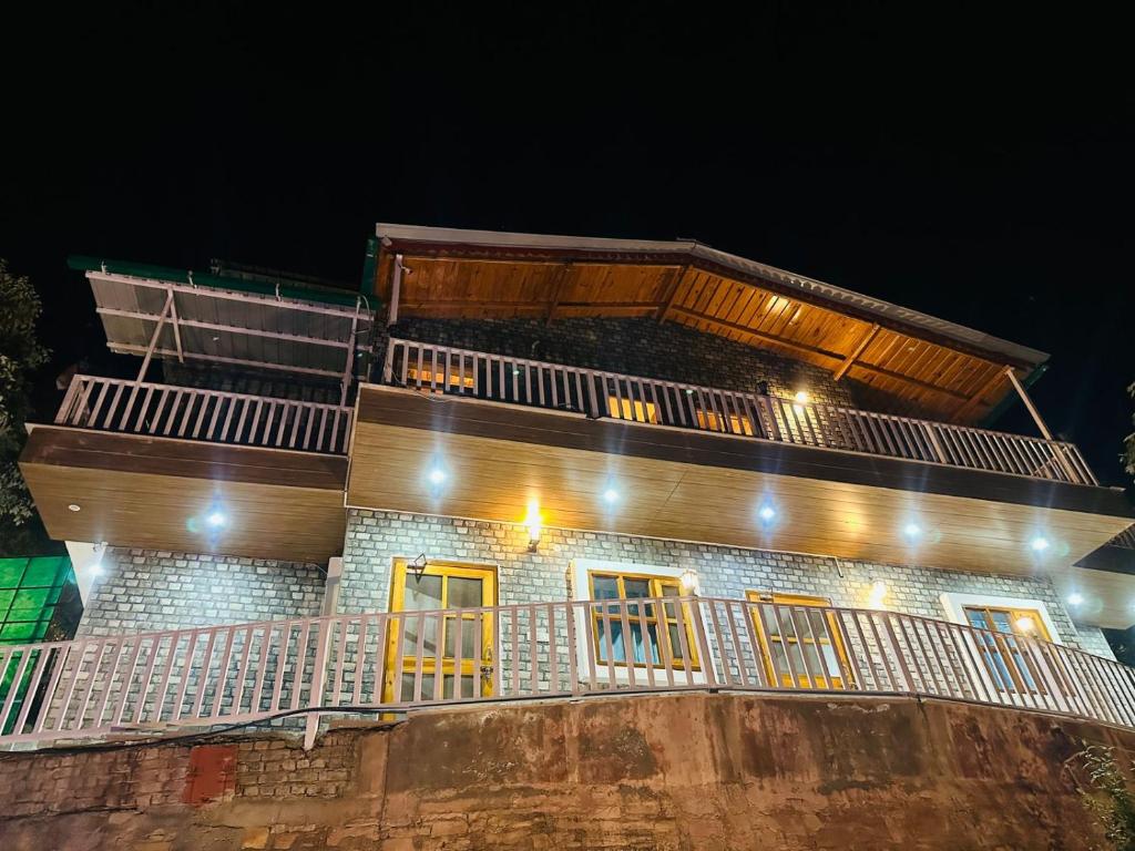a building with yellow doors and a balcony at night at frozen valley in Mukteshwar