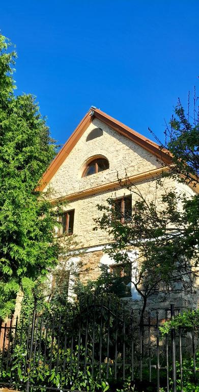 a brick building with a fence in front of it at Statek Vojtěšín in Vojtěšín