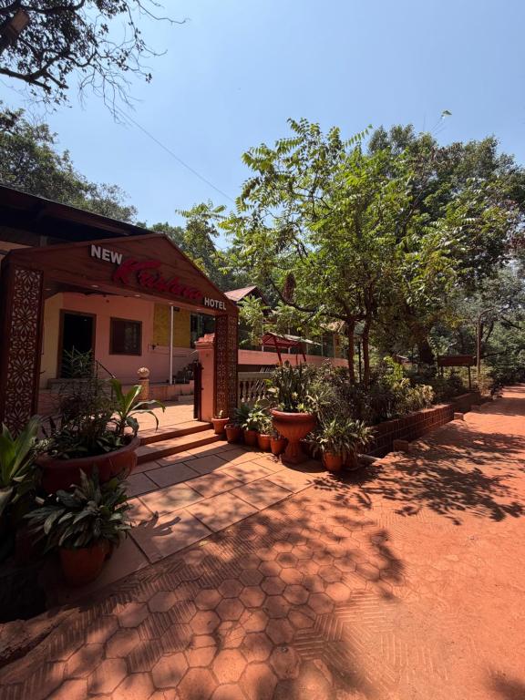 a building with potted plants in front of it at New Krishna Hotel Matheran in Matheran