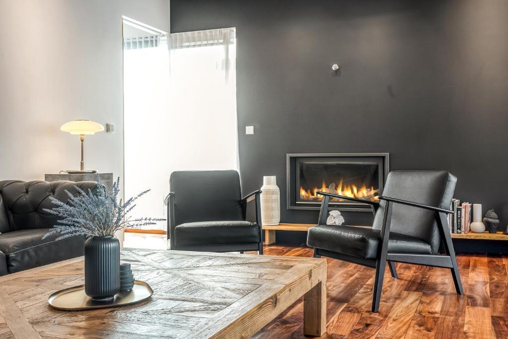 a living room with two chairs and a fireplace at B2 Apartments by Heimaleiga in Reykjavík