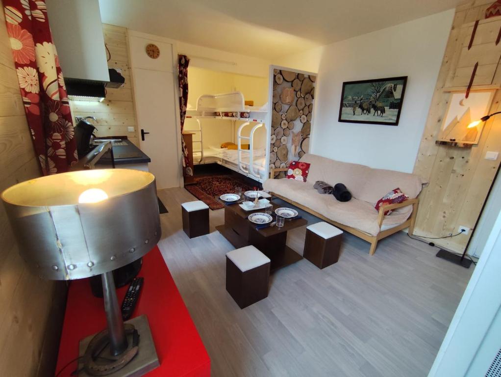 a living room with a couch and a table at La Tanière in Ustou