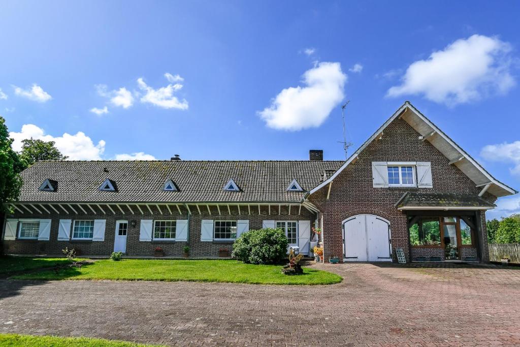 a large brick house with a driveway at La Bulle in Verton