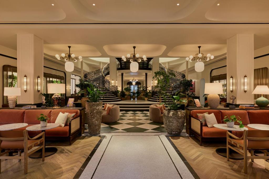 a lobby of a hotel with couches and tables at Six Senses London in London