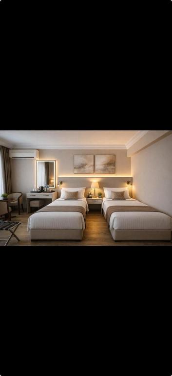 a room with four beds with lights on them at Hotel Buyuk Sahinler in Istanbul