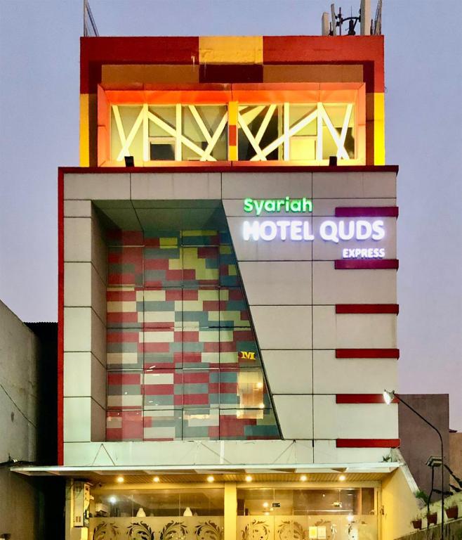 a building with a sign on the side of it at Hotel Quds Express Syariah in Jakarta