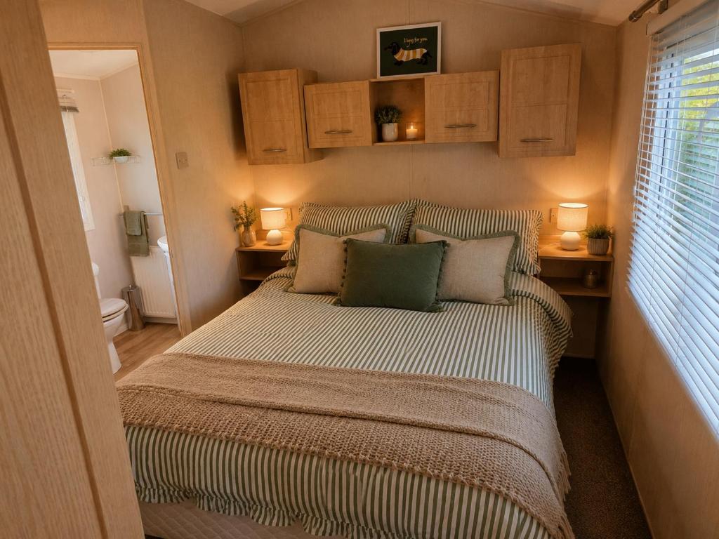a small bedroom with a bed with two pillows at High View in Freystrop