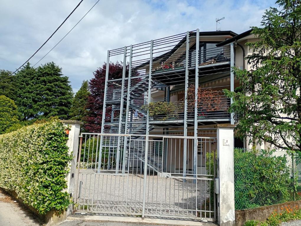 a house with a gate and a fence at Bright apartment between Como and Milan in Lurago Marinone