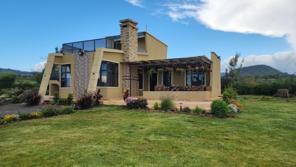 a house with a lawn in front of it at Blooming Sanctuary in Ruiru