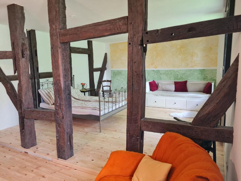 a living room with a couch and a bed at Große Ferienwohnung 160qm in einzigartigem historischen 700 Jahre altem Gebäude in Hardegsen