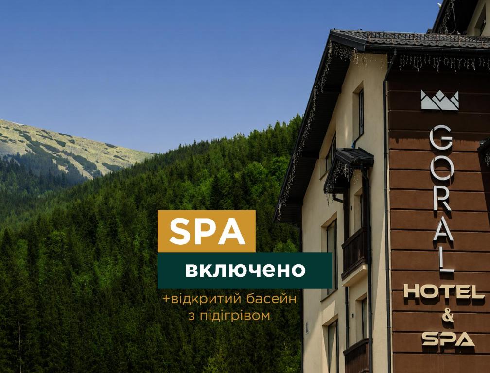 a sign for a hotel on the side of a building at Goral Hotel & Spa in Bukovel