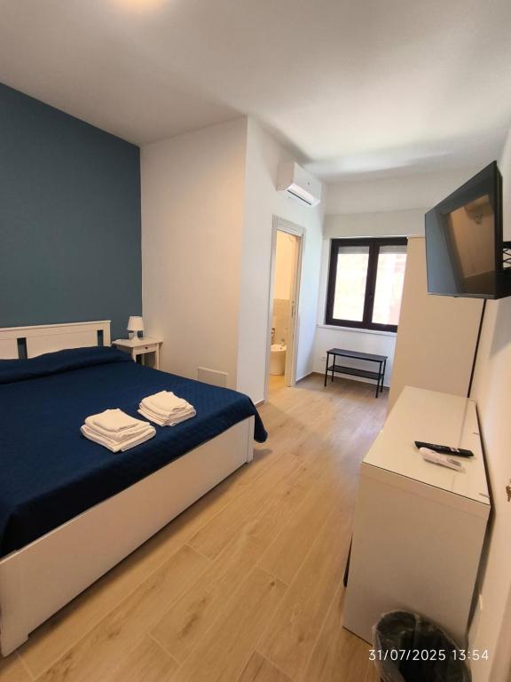 a bedroom with a bed and a flat screen tv at dante 55 in Agrigento