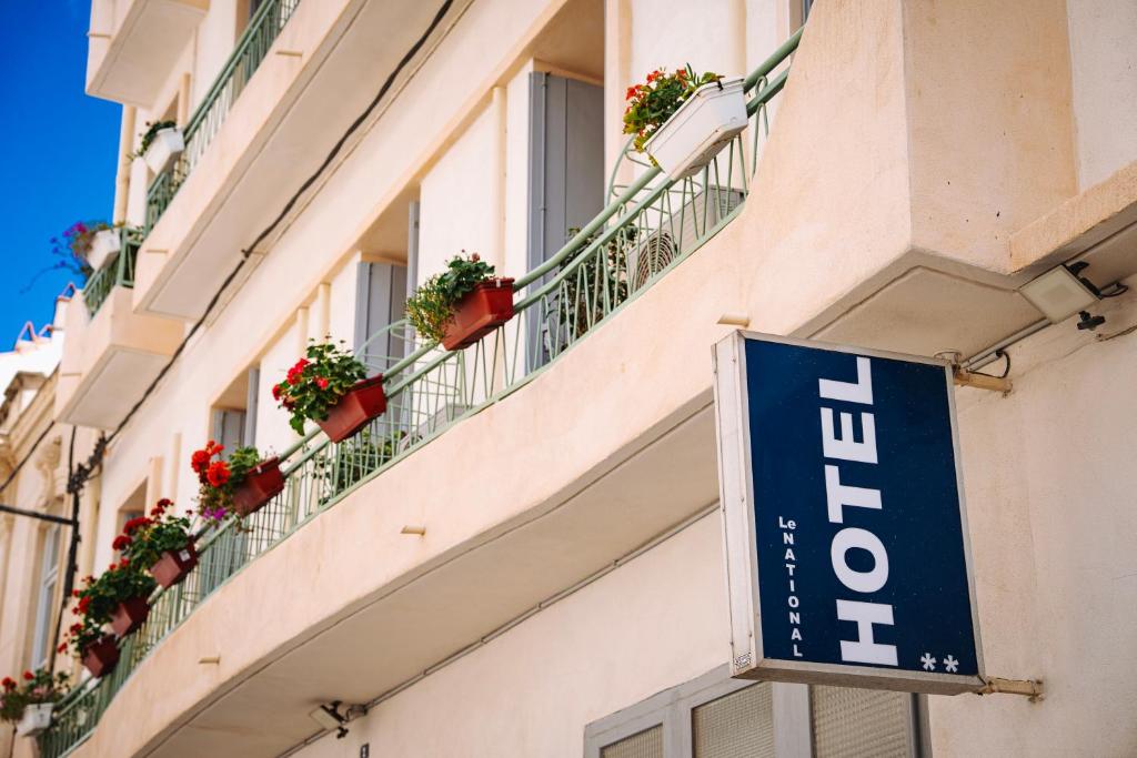 a hotel sign on the side of a building at Le National Sète Centre Gare,Ascenseur in Sète