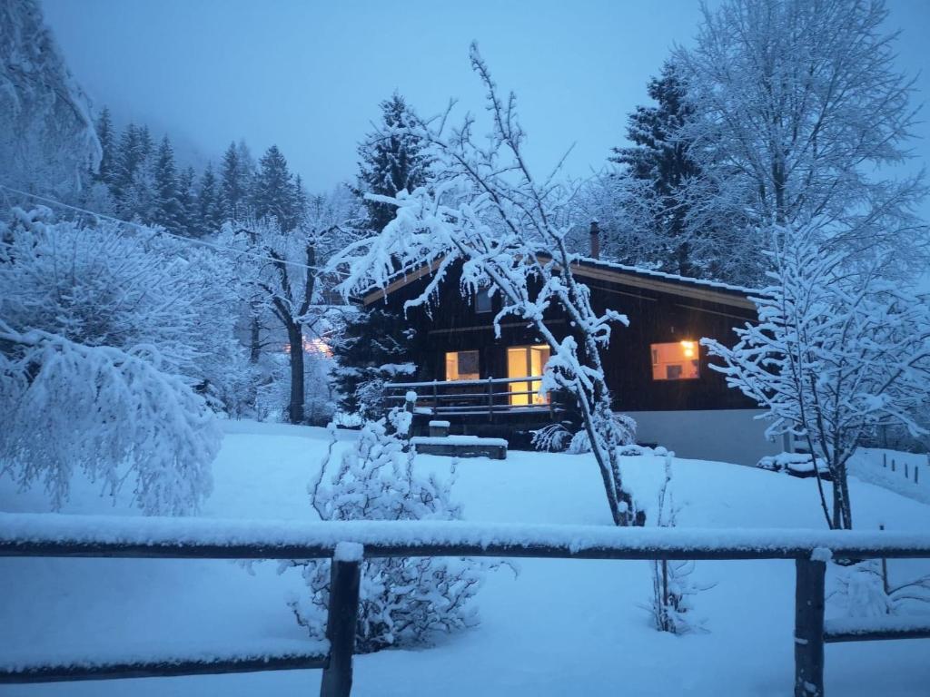 a cabin in the snow at night at Chalet Rustifol in Orsières