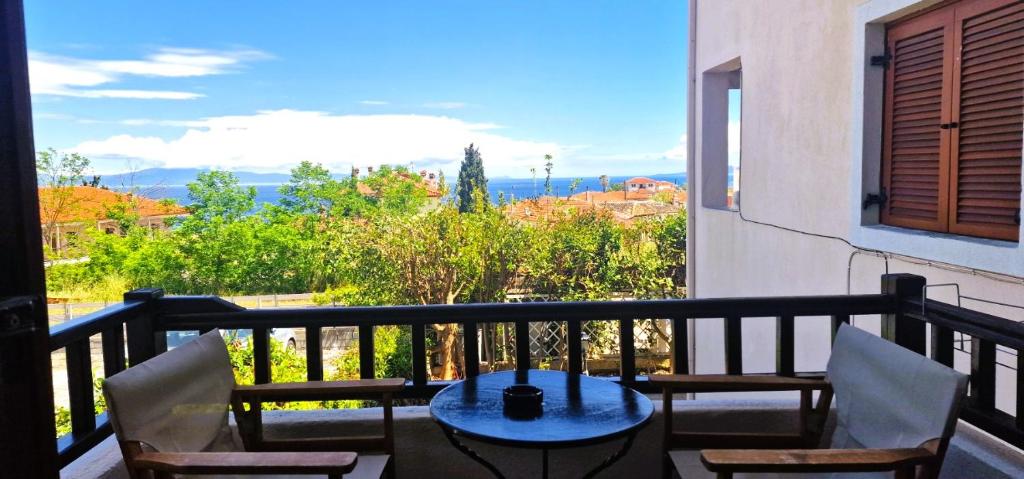 a balcony with a table and chairs and a view at Villa Galani Afitos in Afitos