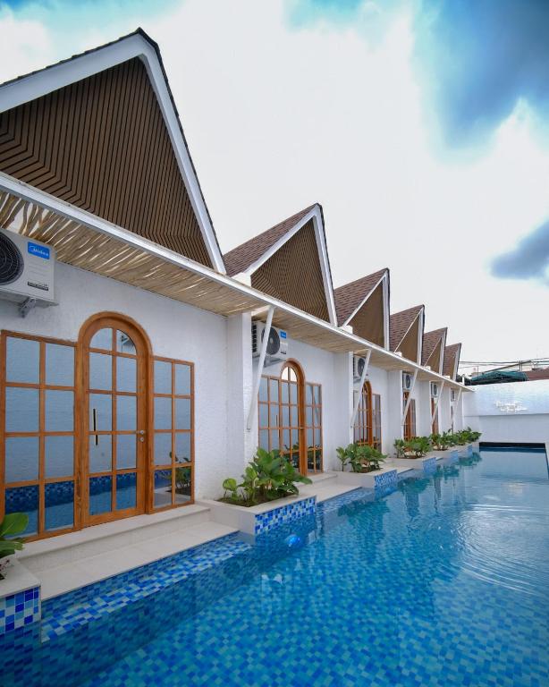 a villa with a swimming pool in a resort at Serenity Garden Villas by Danka Hospitality in Hang Nadim International Airport