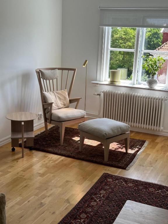 a living room with a rocking chair and a table at Fantastic accommodation in central Kalmar in Kalmar