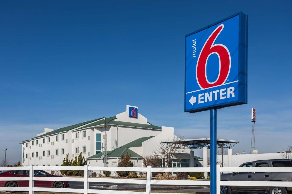 a sign in front of a building with a kennier at Motel 6-Dale, IN in Dale