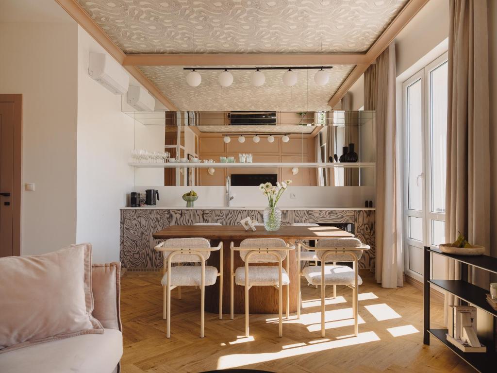 a kitchen with a table and chairs in a room at Marszałkowska Luxury Apartments by Sofija in Warsaw