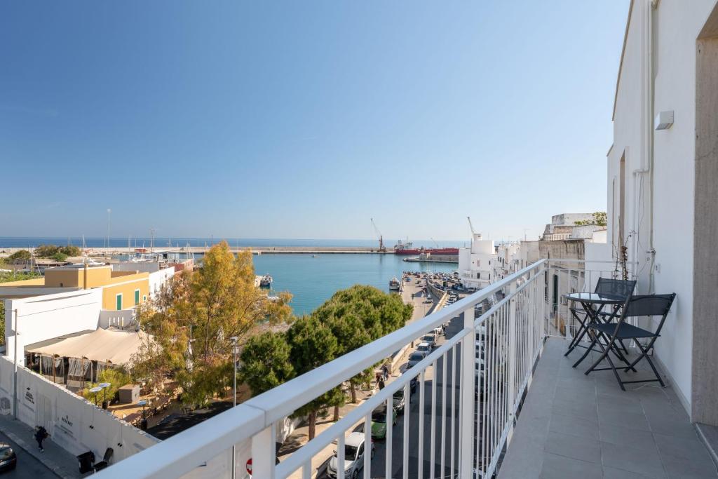 a balcony with a view of a body of water at Relax in Riva by MONHOLIDAY in Monopoli
