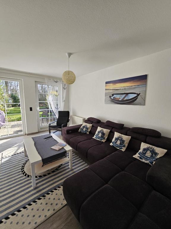 a living room with a couch and a table at Ferienhaus 1260 in Tossens in Tossenserdeich