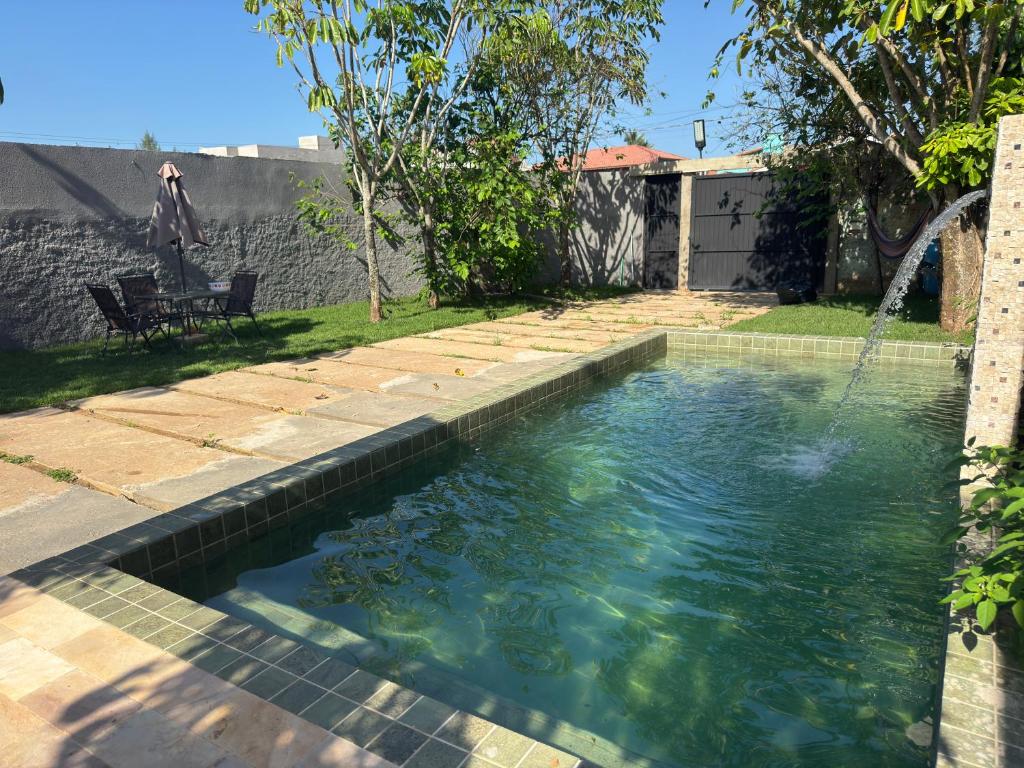 a swimming pool in the backyard of a house at Caminho do mar in Itanhaém
