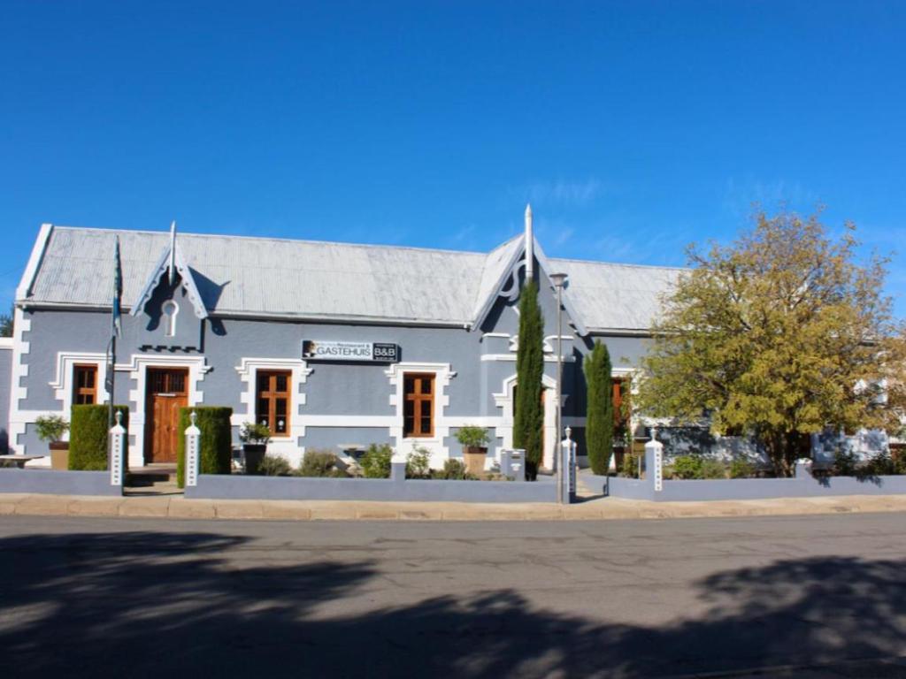 a large white building on the side of a street at Die Blou Nartjie in Calvinia