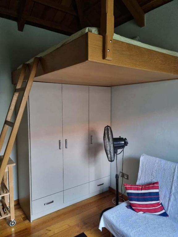 a room with a loft bed and a couch at Οικοδέσπινα in Mytilene