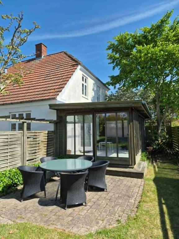 a gazebo with a table and chairs on a patio at Nybo House in Præstø