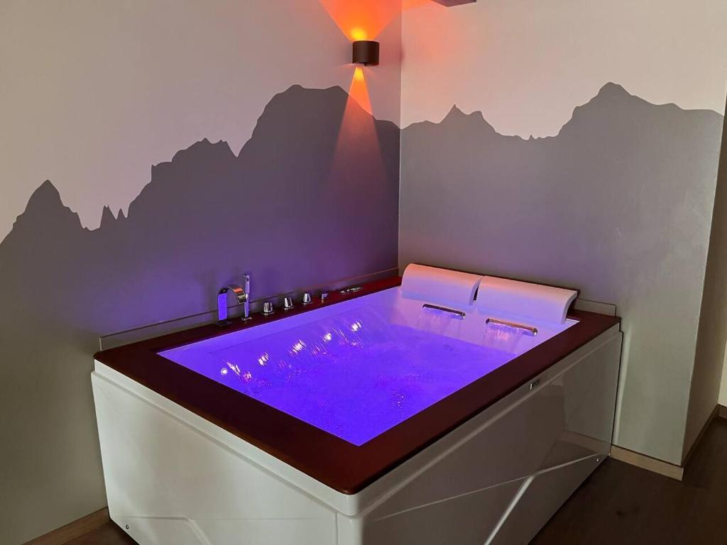 a bathroom with a hot tub with purple lighting at Lo Blan Morgex in Morgex