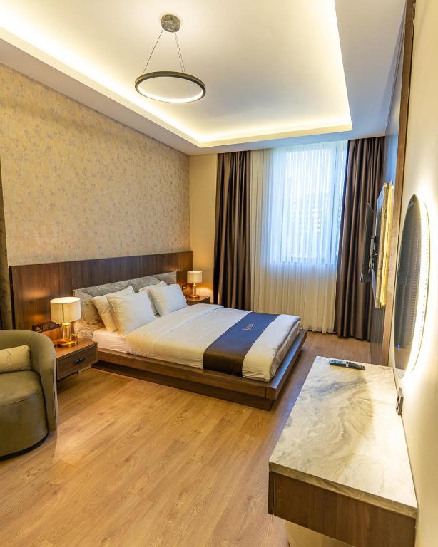 a hotel room with a bed and a couch at Rossa Marin Hotel in Darıca