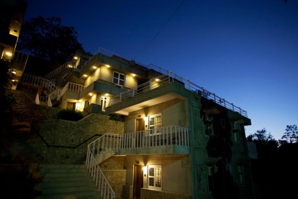 a building with stairs leading up to it at night at Hotel Aravali in Mount Ābu