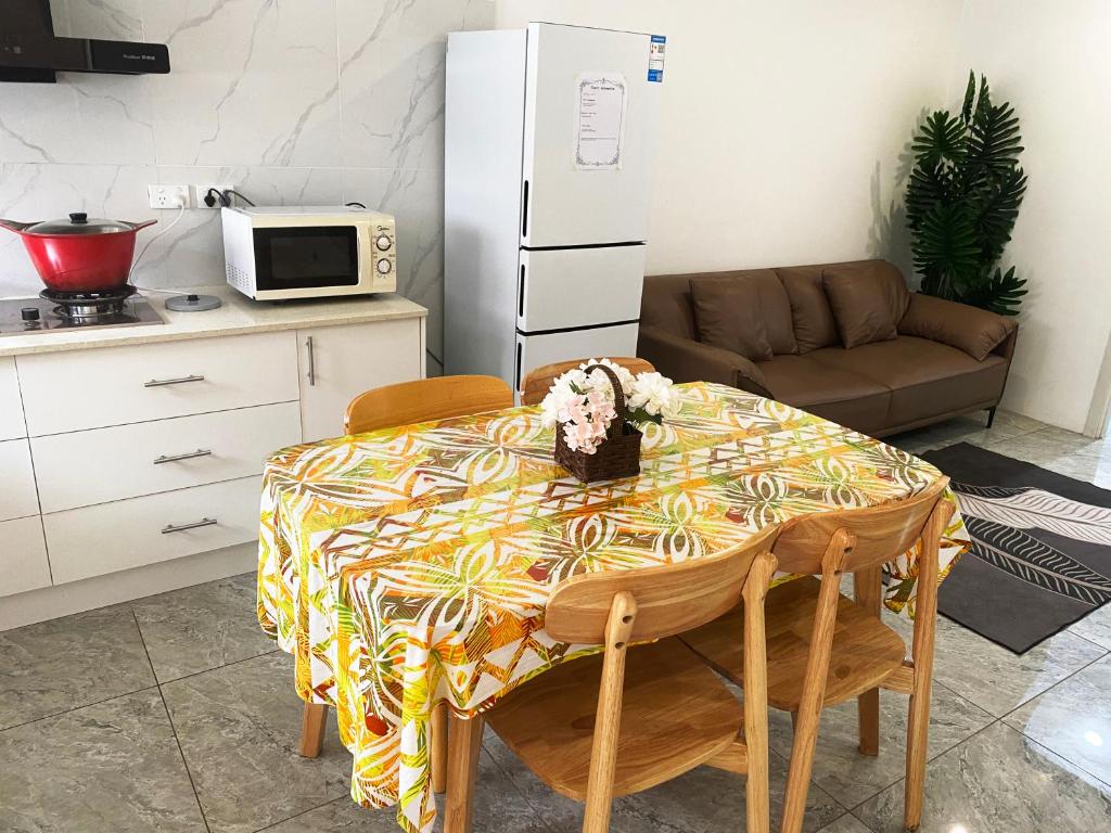 a kitchen with a table with a table cloth on it at Nadi Easy Stay Near McDonalds in Nadi