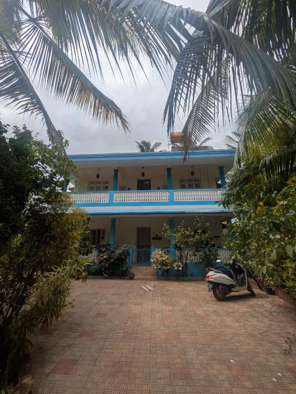 a house with a scooter parked in front of it at Amore Holiday Home in Canacona