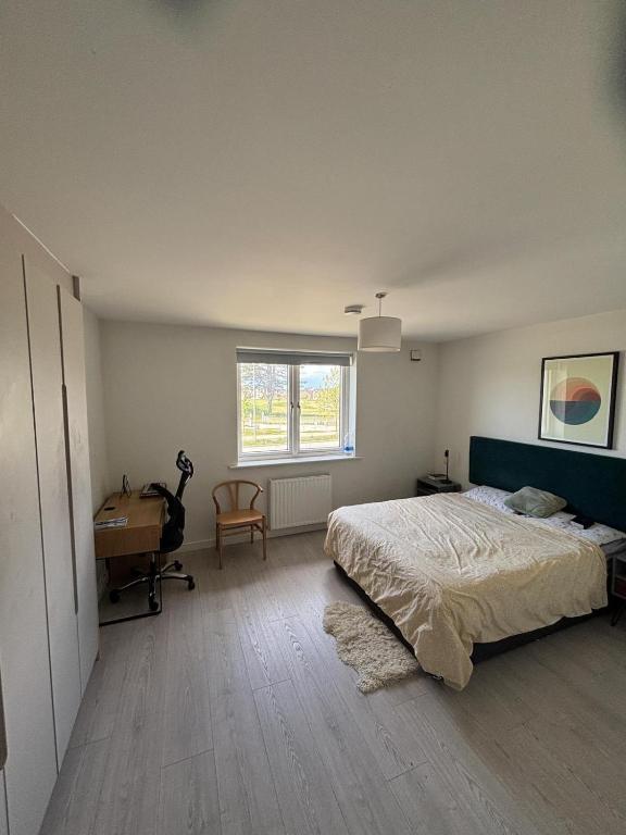 a bedroom with a bed and a desk and a window at En-suite Double Bedroom Adamstown in Lucan